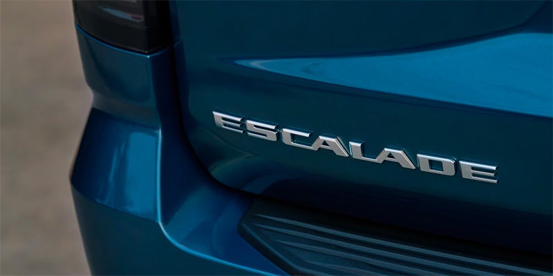 Escalade nameplate on the rear of a blue Cadillac